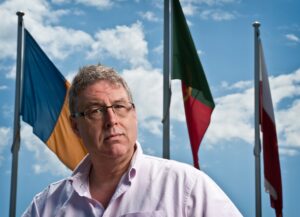 Gary France in front of international flags